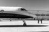 2 asscociates talking outside an aircraft on the field